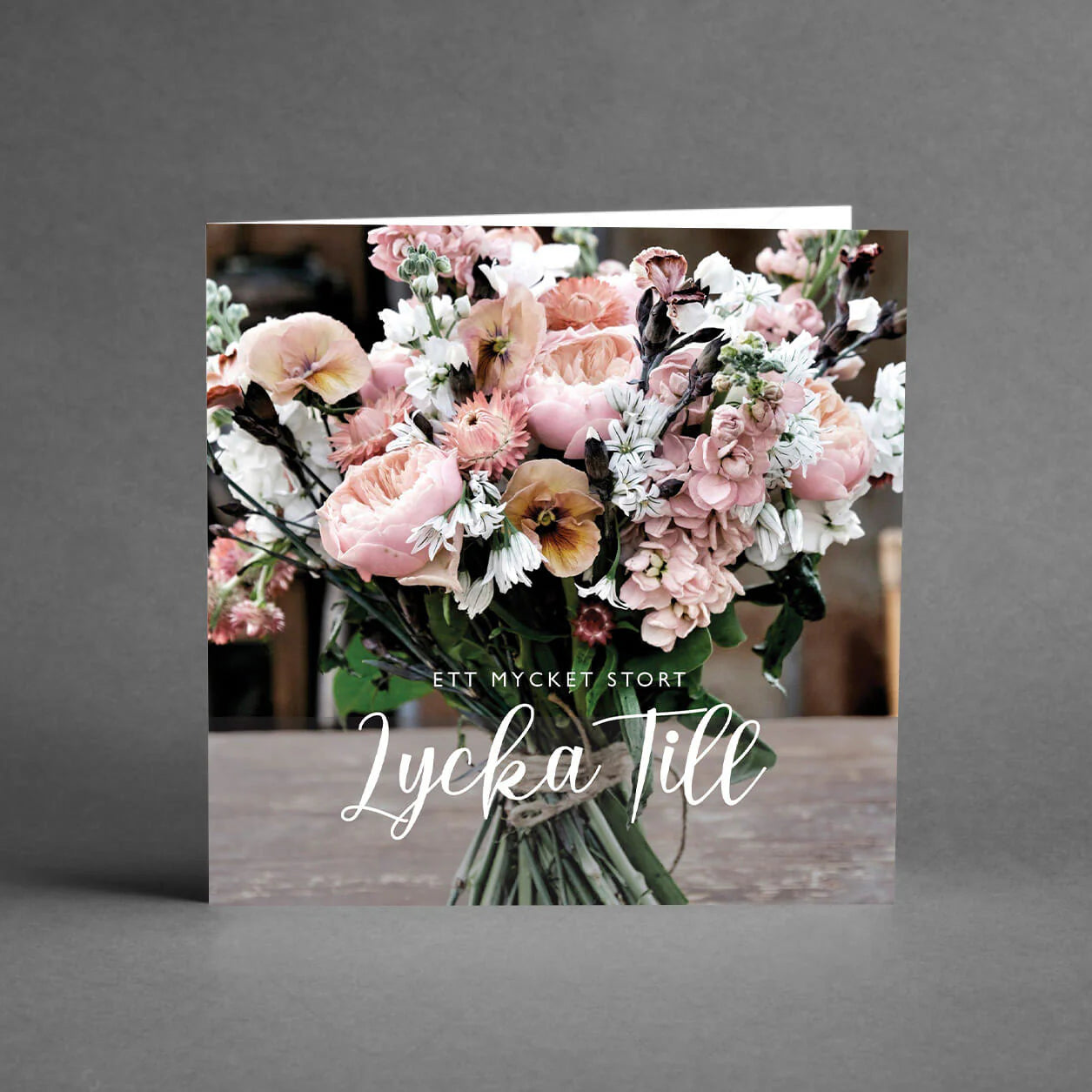 Ett gratulationskort med motivet av en blombukett och texten "Ett mycket stort Lycka till"